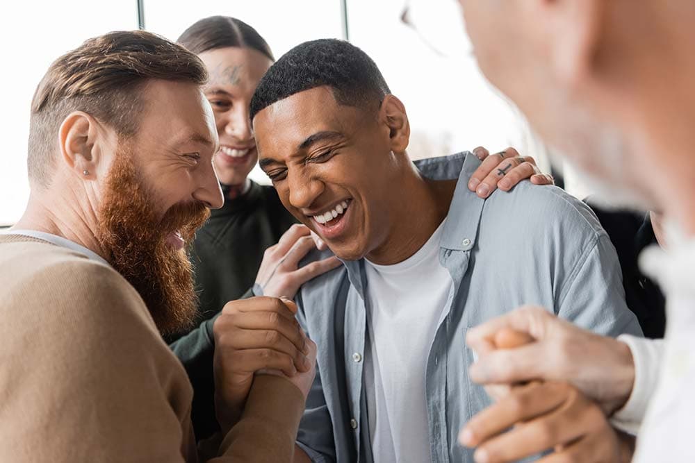 a happy group of people supporting each other in alcohol addiction treatment