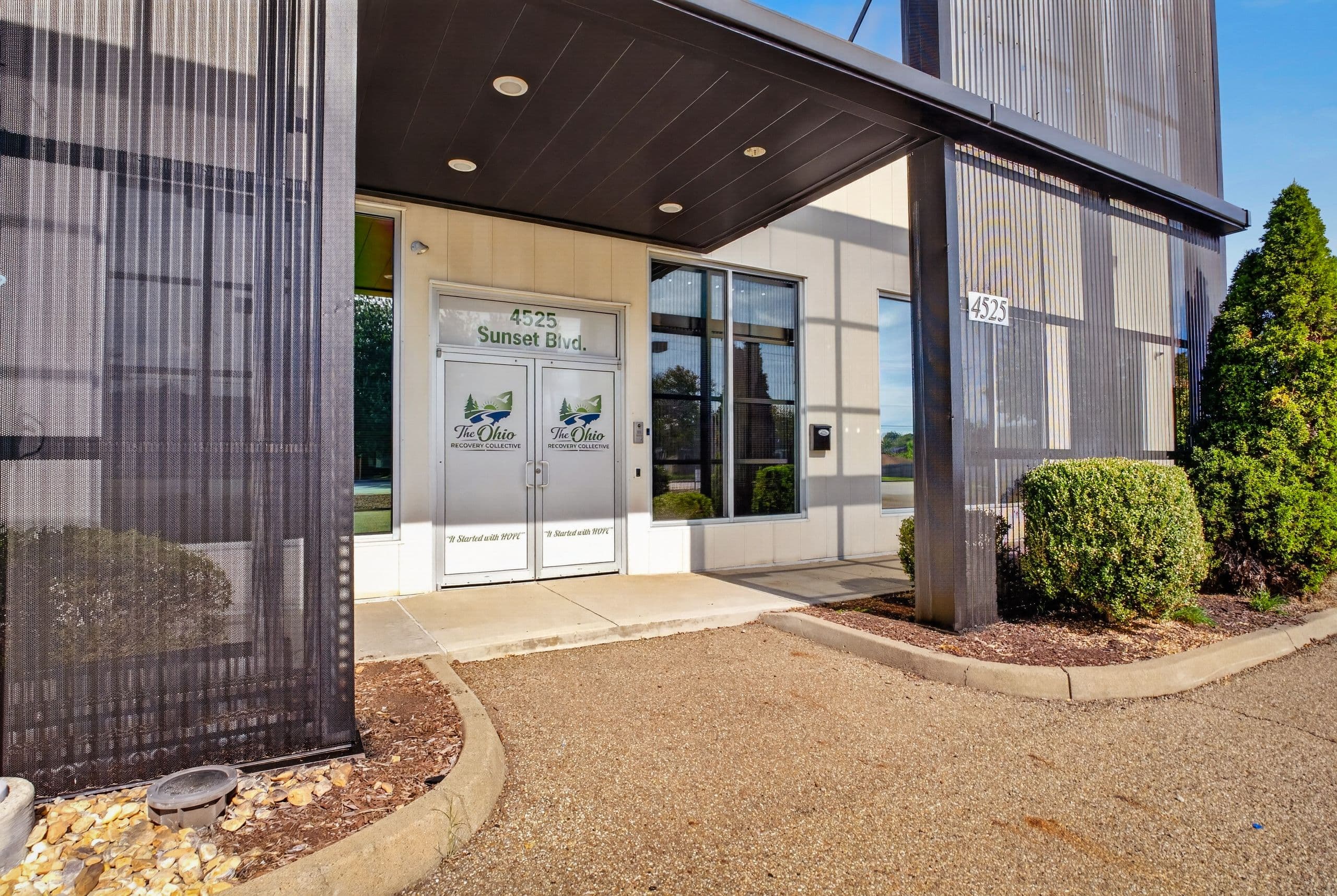 The covered front entrance, with The Ohio Recovery Collective logo on the glass doors