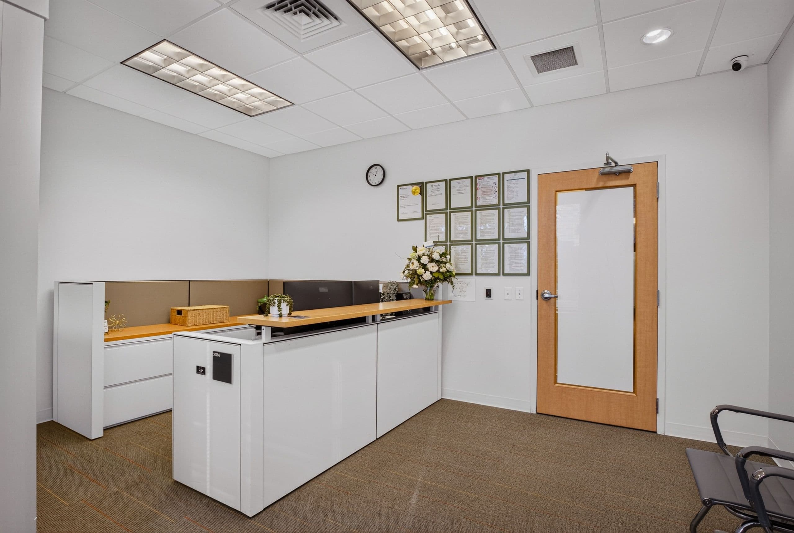 The front desk, with framed certificates on the wall behind it