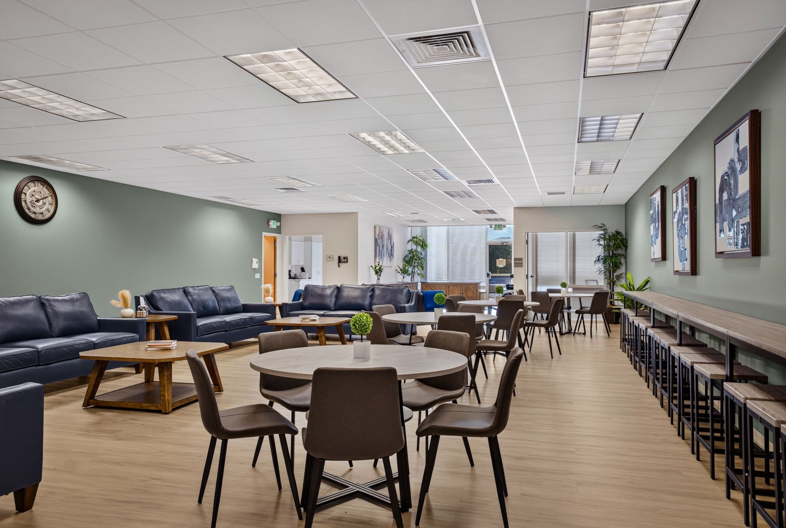 The length of the lounge, with tables, sofas and a bar counter along one wall