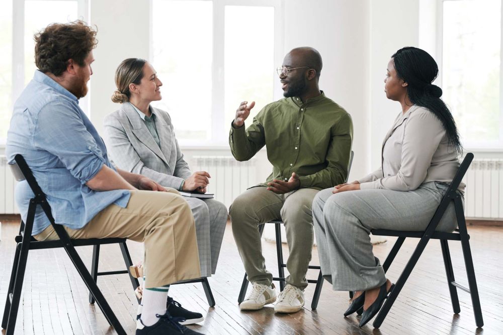 addiction-group-therapy a man talking in an addiction group therapy session
