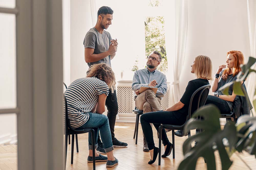 a man addressing a cocaine addiction rehab group