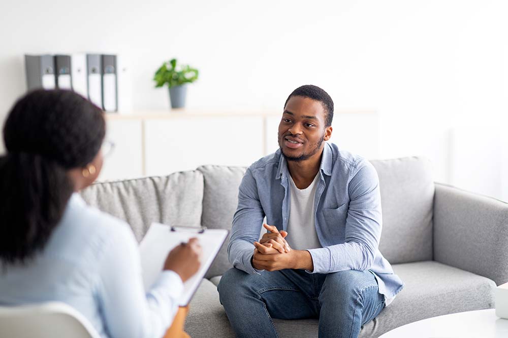 cognitive-behavioral-therapy-session a man talking to his therapist in a cognitive behavioral therapy session